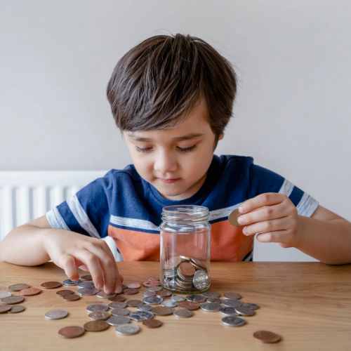 Small Boy playing with coins| Fundraising | Bonneville Academy